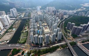 Aerial view of a dense urban area with tall apartment blocks water channels and multiple bridges