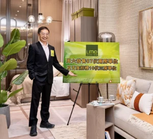 Man in a dark suit standing in a stylish showroom pointing to a large green promotional sign that reads Lime Spark in Chinese and English